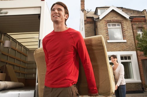 Van loading scene showing careful handling and protective wrapping